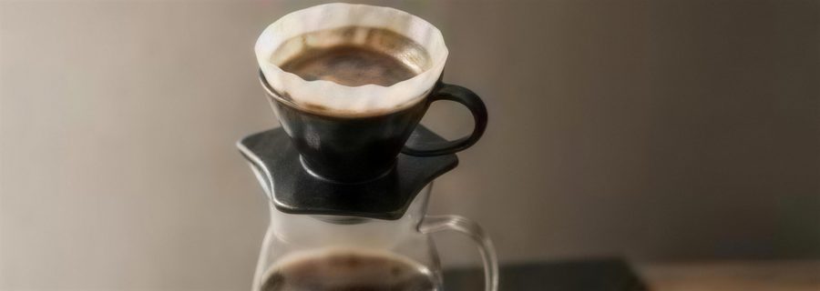 Pour-over coffee brewing into a glass carafe